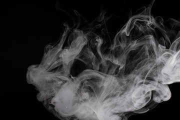 Closeup shot of white smoke on the black background