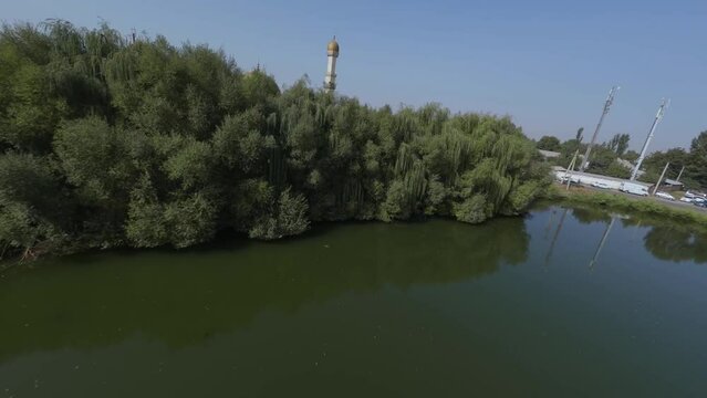 Summer nature pond countryside park Muslim church Islamic crescent architecture panorama aerial view. Spirituality religious building exterior mosque rooftop picturesque suburb forest plant landscape