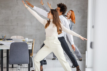 Office workers workout during coffee break. They try to exercise and practice yoga to relax before working day.
- 549763619
