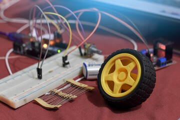 Robotic wheel, register, breadboard, battery, motor driver, jumper wire, Arduino and hardware project