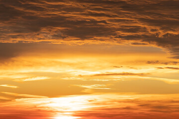 Naklejka na ściany i meble Orange dawn. dramatic sky at dawn. Orange dawn at sea