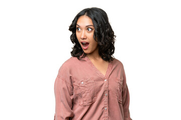 Young Argentinian woman over isolated background doing surprise gesture while looking to the side