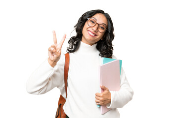 Young Argentinian student woman over isolated background smiling and showing victory sign