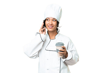 Young chef Argentinian woman over isolated background holding coffee to take away and a mobile