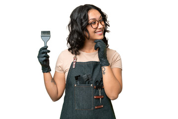 Young argentinian hairdresser woman over isolated background looking to the side and smiling