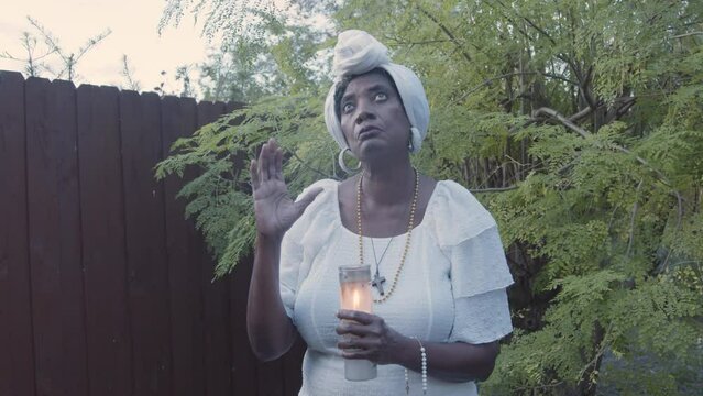 Woman praying with candle
