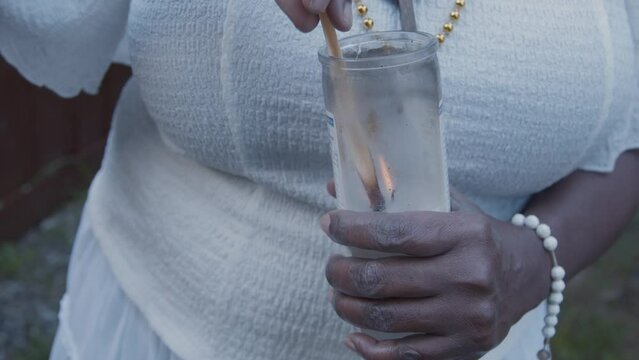 Woman lighting white candle 