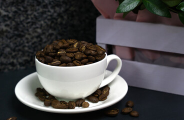 Aromatic coffee beans in a cup on the table. Close-up. Copy space. Selective focus.