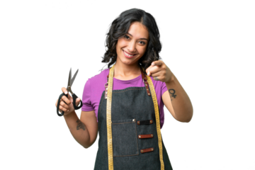 Young seamstress argentinian woman over isolated background pointing front with happy expression