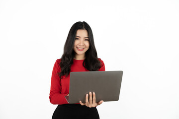 Naklejka premium Happy asian business woman holding laptop computer and looking at the camera over white background.