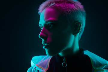 Futuristic woman under colorful illumination