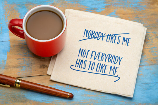 Nobody likes me. Not everybody has to like me. Inspirational handwriting on a napkin with coffee. Social media and personal development concept.