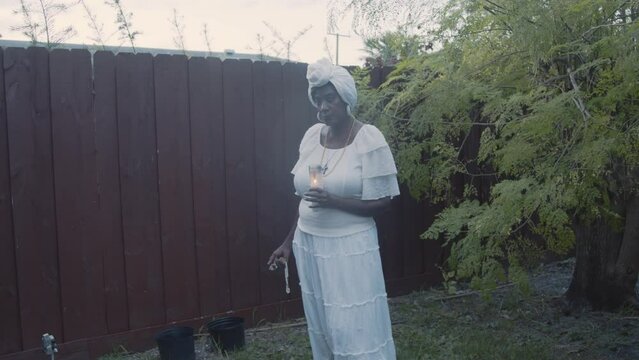 Woman dressed in white standing in nature