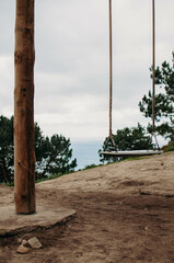 swing with city and ocean view