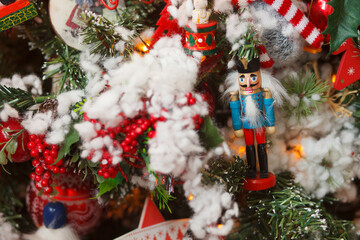 new year, nutcracker christmas decoration toy on snowy fir free