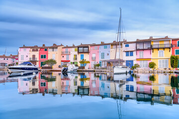 Fototapeta na wymiar Scenic view of Port Grimaud village in south of France in autumn pastel colors against dramatic sky