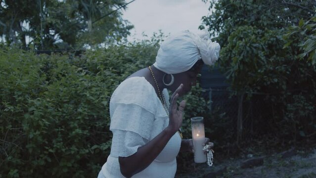 Woman blowing out candle