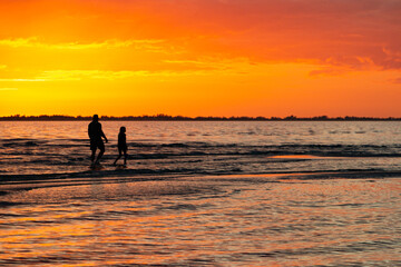 beach sunset parent child walking