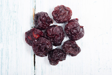 dried cherry fruits on white wooden