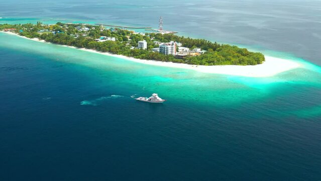 Tropical local island Ukulhas in Maldives with white sand beach and turquoise sea water in North Ari Atoll. Scenic landscape. Drone aerial view video footage.