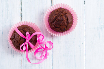 chocolate muffins on white wooden table