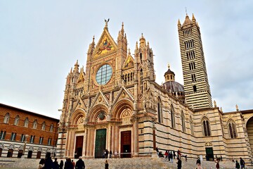 external facade of cathedral of Santa Maria Assunta in the historic center of Siena in Tuscany, Italy - obrazy, fototapety, plakaty