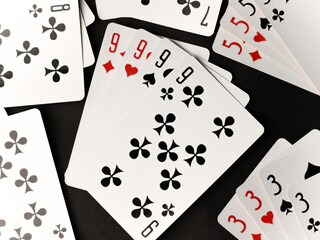 gambling card game. cards tens nines black and red diamonds worms clubs and spades on a dark...