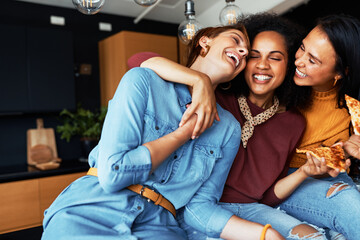 Diverse friends laughing and having pizza