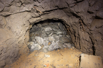 Old gold mine underground tunnel with collapsed roof