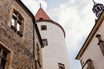 Fototapeta na wymiar Krivoklat, Czech Republic, 21 August 2022: Courtyard of fortified medieval royal gothic castle, National cultural landmark in summer day, Fortress walls and large round tower