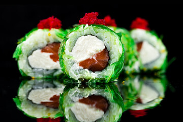 Sushi rolls with tuna, cream cheese, seaweed, topped with red flying fish caviar.