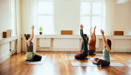Yoga teacher leading students in meditation