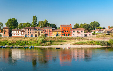 Fototapeta na wymiar Colored houses along the south bank of river Ticino in Pavia in northern Italy