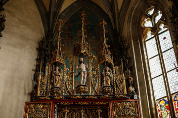 Krivoklat, Czech Republic, 21 August 2022: fortified medieval royal gothic castle, National cultural landmark, chapel interior with wooden carved altar depicting Jesus Christ and the Virgin Mary