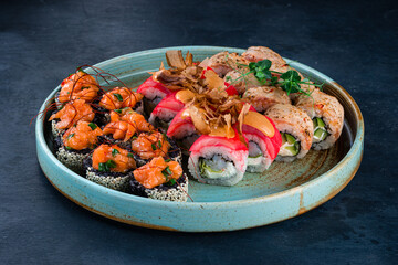 Set of japanese sushi rolls with tuna, sea bass, salmon, cucumber, avocado and cream cheese.