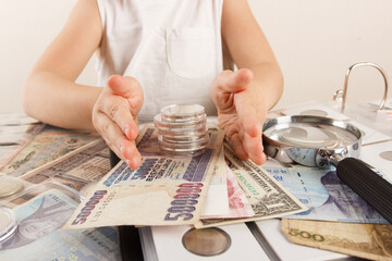 Child with different coins and banknotes