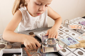Child with different coins and banknotes