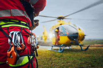 Selective focus on safety harness of paramedic of emergency service in front of helicopter. Themes...
