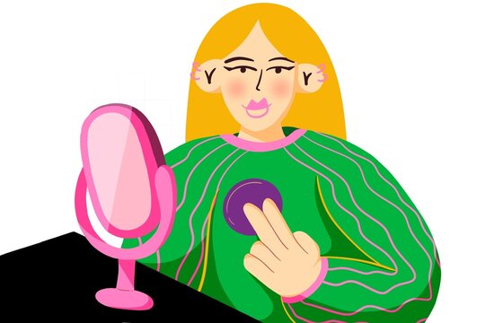 Woman with long blonde hair puts on makeup while looking in the mirror