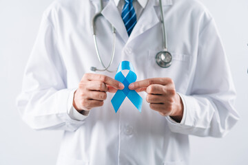 doctor in a white coat hands holding Blue ribbon for supporting people living and illness, Colon...