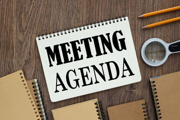 Meeting Agenda text on notepad on desktop top view