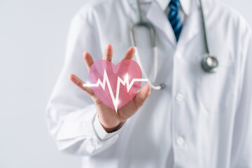 doctor in a white coat touching virtual red heart donation with pulse cardiogram, health care,...