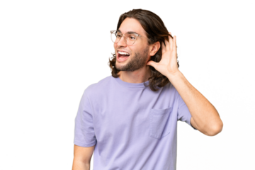 Young handsome man over isolated background listening to something by putting hand on the ear