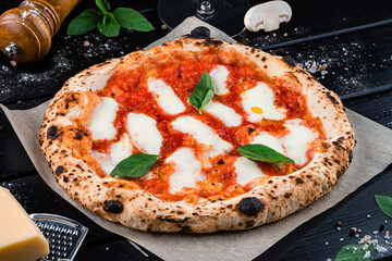 Italian cuisine pizza with mozzarella, tomato sauce, spinach on a thick dough.