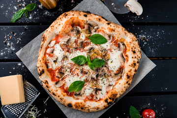 Neapolitan pizza with cheese parmesan, champignon mushrooms, tomato sauce, spinach on thick dough with spices from oven. - obrazy, fototapety, plakaty