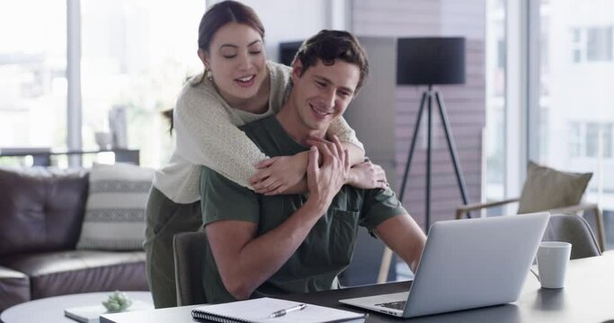 Laptop, couple and love hug in home with husband, freelancer or remote worker working at desk or table. Romance, affection and happy woman hugging or embrace man on computer in living room of house.