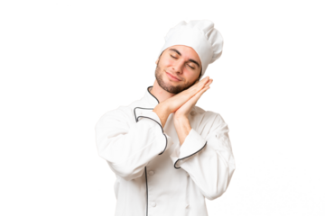 Young handsome chef man over isolated background making sleep gesture in dorable expression