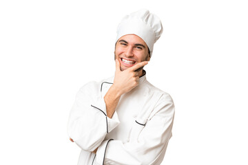 Young handsome chef man over isolated background smiling