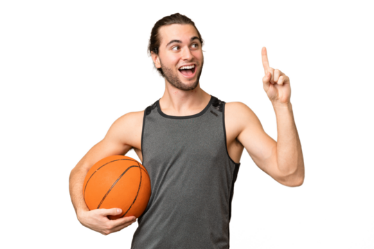 Young handsome man isolated on green chroma background playing basketball and having an idea