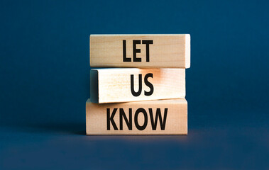 Let us know symbol. Concept words Let us know on wooden blocks on a beautiful grey table grey background. Business and let us know concept. Copy space.